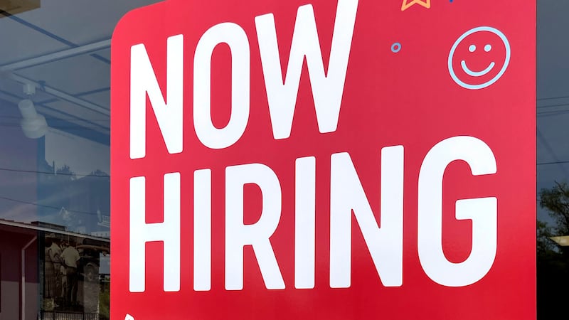 A hiring sign is displayed at a fast food restaurant in Northbrook, Ill., Monday, May 22,...