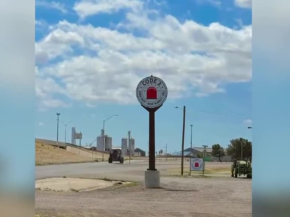 An old gas station sign now stands as a landmark representing the lives of three first...