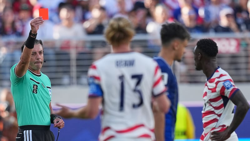El árbitro brasileño Raphael Claus expulsa a Folarin Balogun (derecha), de Estados Unidos,...