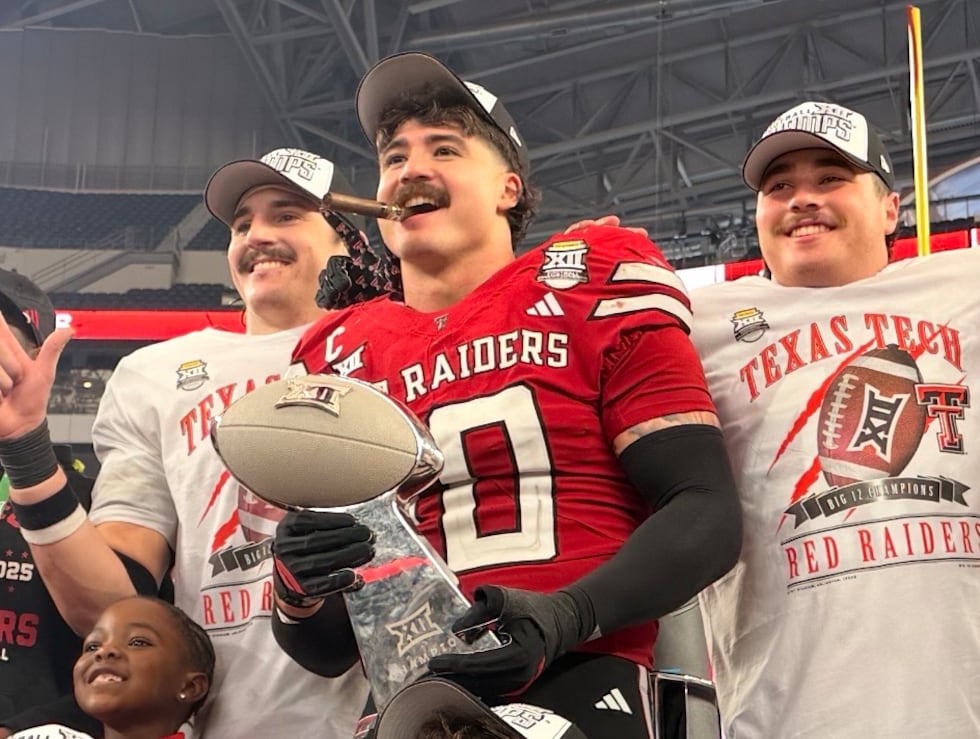 Texas Tech's Jacob Rodriguez holds the Big 12 Championship trophy after the Red Raiders cruise...